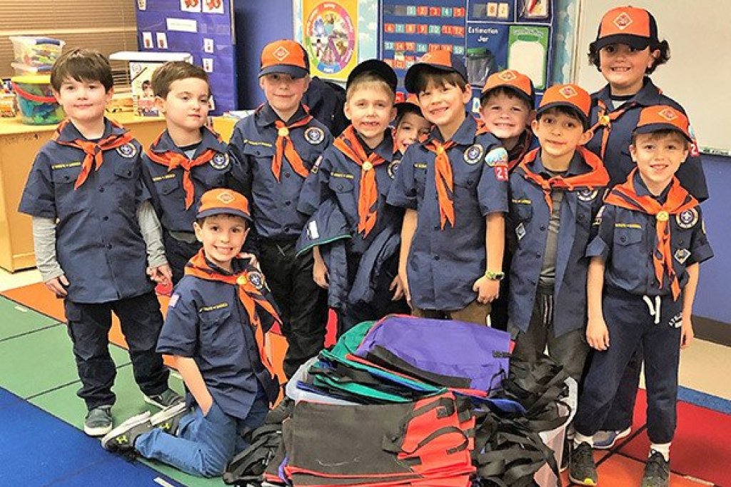 a group of boy scouts posing for a photo.