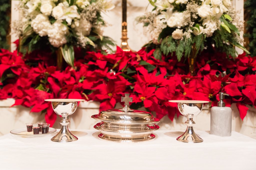 communion serving elements with poinsettias in the background.