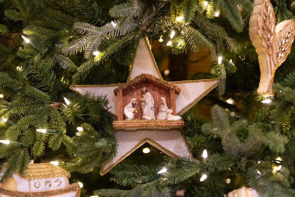gold and white christmas ornament with nativity scene.