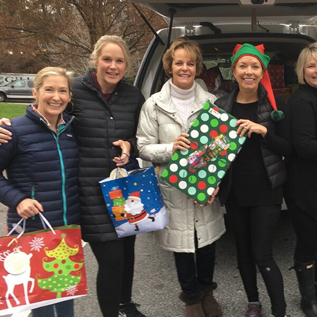 a group of women holding shopping bags.