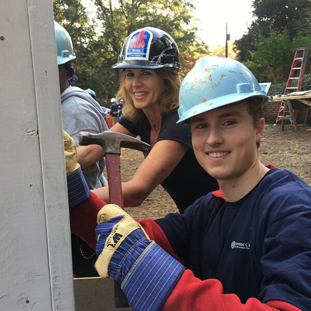 women wearing hats and holding a hammer.